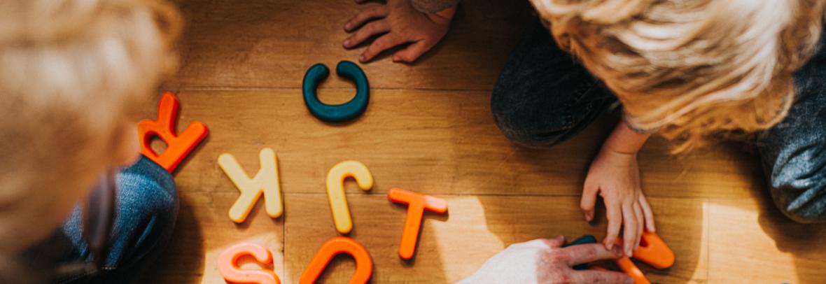 children playing with colorful letters 