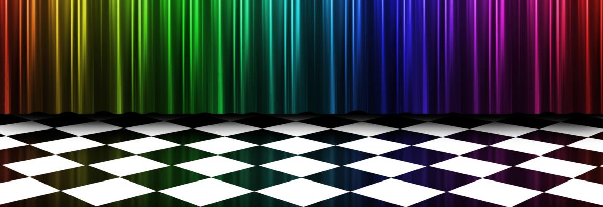 A rainbow colored curtain behind a floor of black and white checkerboard tiles