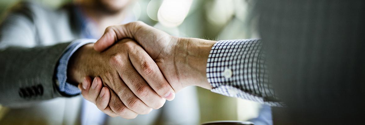 close up photo of two business men shaking hands