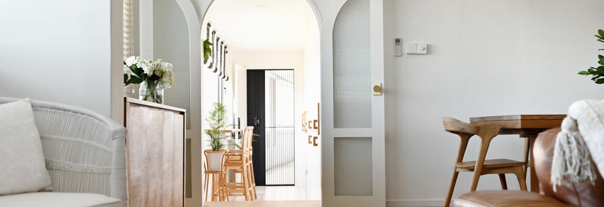 Arched doorway into a modern luxury home 