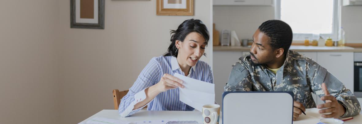 Military home buyer working with agent at kitchen table 
