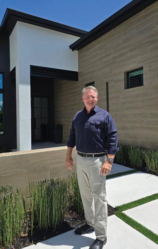 Photo of Greg Gorman in front of a luxury home