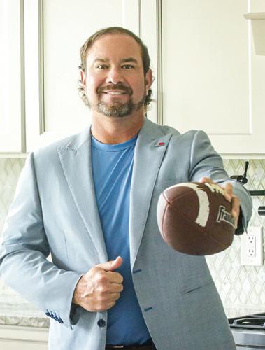 Photo of Brandon Rimes holding a football in hand