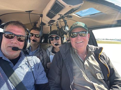 Photo of Billy Rollins in a helicopter with potential buyers