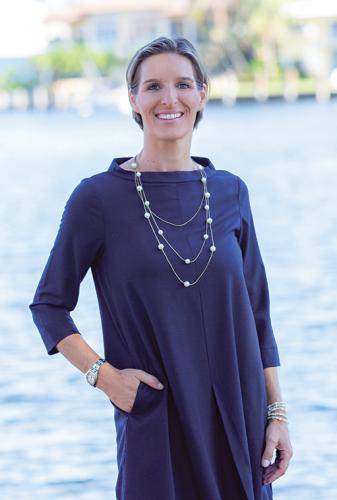 Photo of Tinka Ellington in blue dress near the waterfront