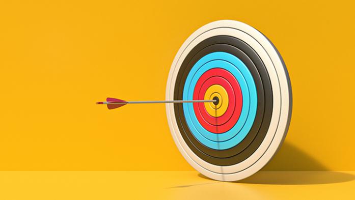 Photo illustration of a target with an arrow in it on a yellow background