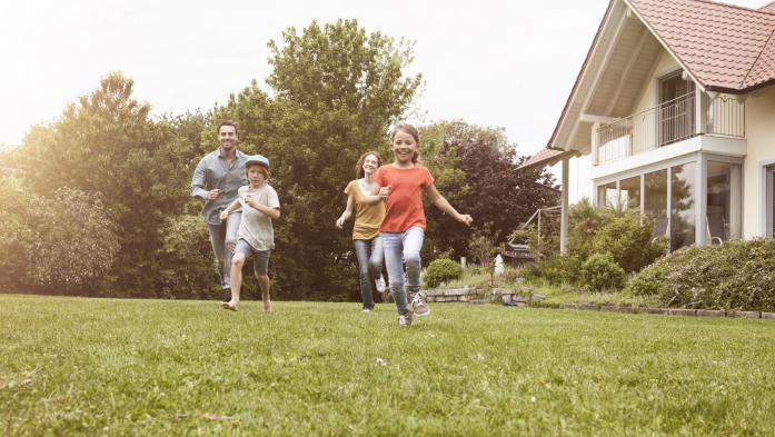 Parents and kids running in yard