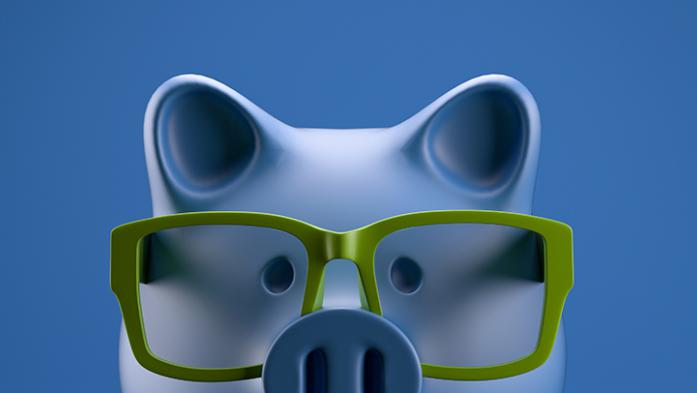 Piggy bank with green glasses on blue background