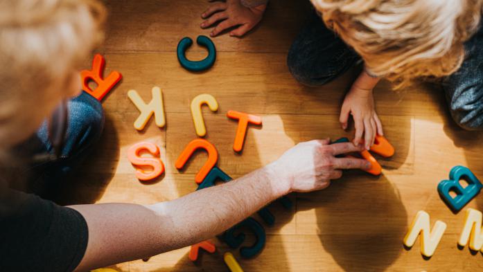 children playing with colorful letters 