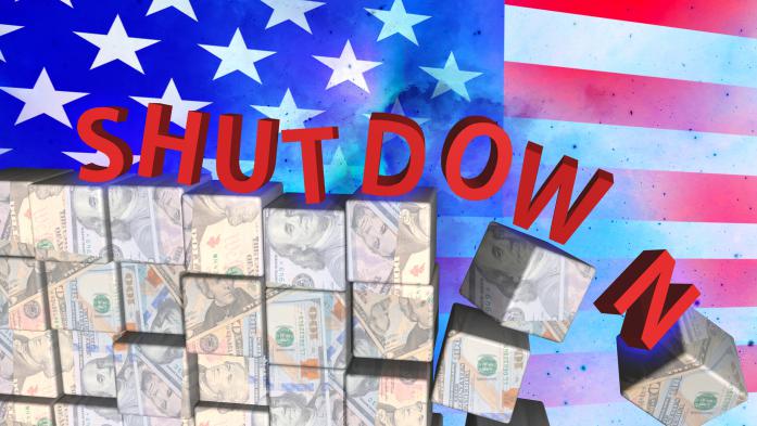 The word shutdown toppling off money with a flag in the background
