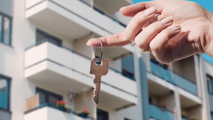  Real estate agent holding keys to new condo