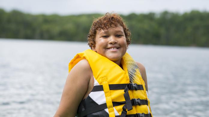 child wearing lifejacket on water