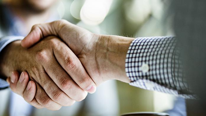close up photo of two business men shaking hands