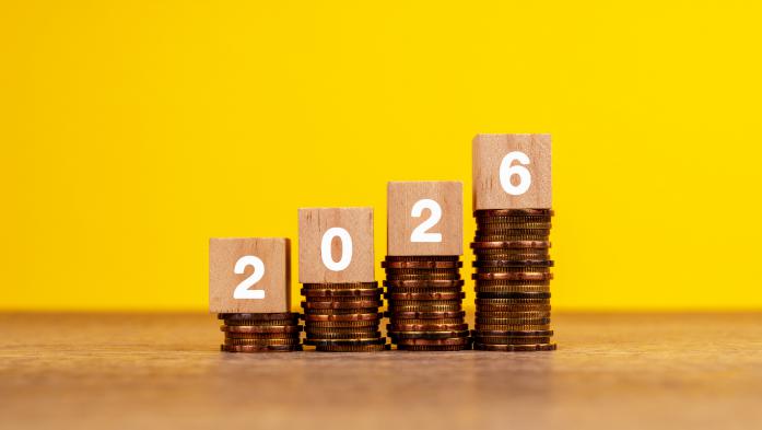 2026 on Wood Block on Top of Stack of Coins