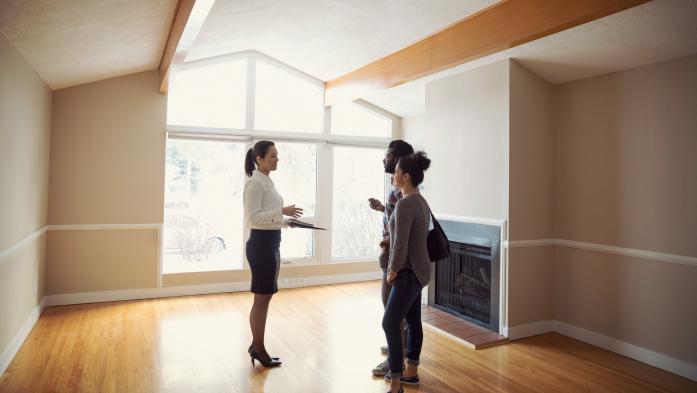 woman showing buyers a house