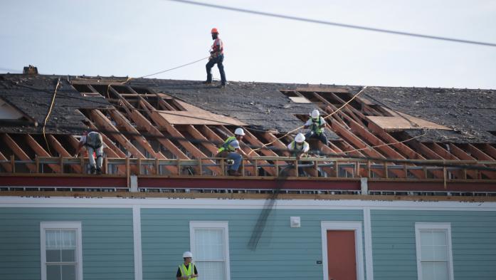 Workers fixing a roof