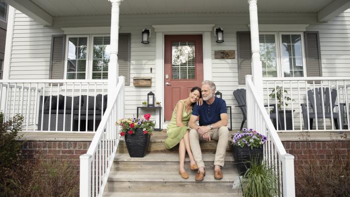 senior citizen couple sitting on porch