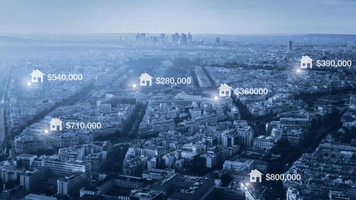 photo illustration of housing prices on aerial image of city