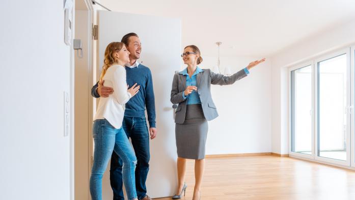 realtor showing a home to a couple
