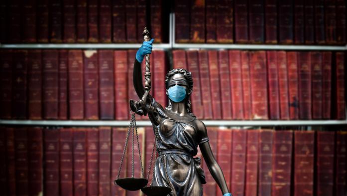 lady justice statue with face mask and gloves