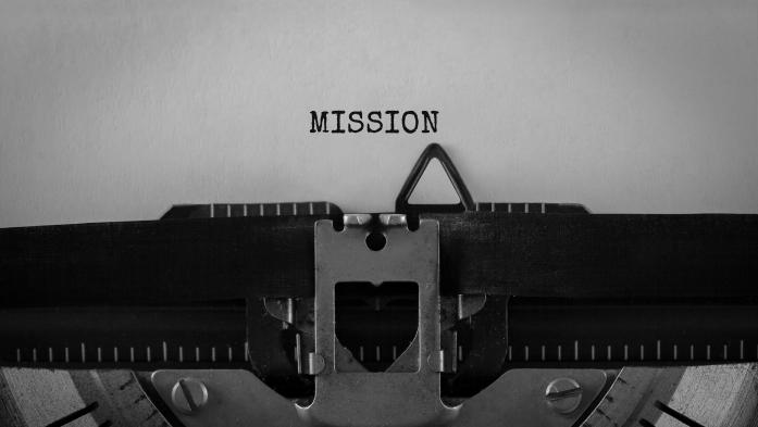 The word "mission" typed on old typewriter