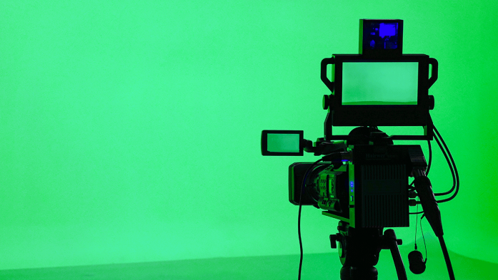 Image of a professional video camera on green background