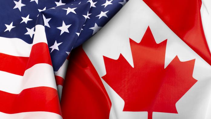 U.S. and Canadian flags folded to show maple leave and stars